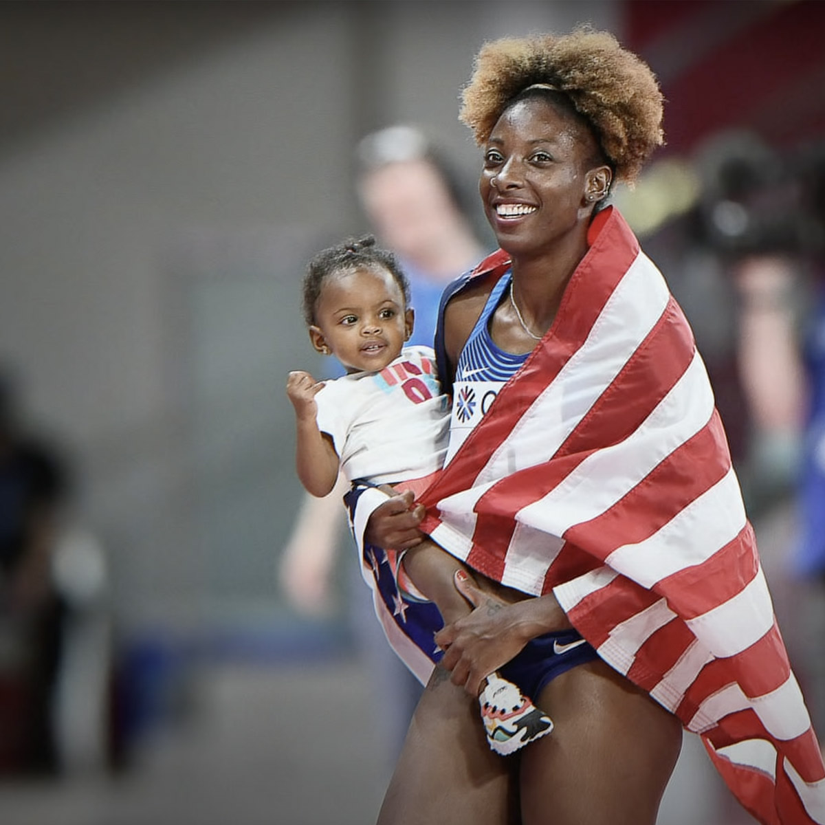 woman in flag holding baby